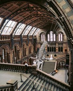 the interior of a train station with people walking up and down it's stairs