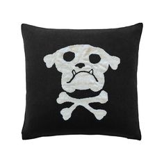 a black pillow with a white skull and crossbones on the front, which is embroidered onto it