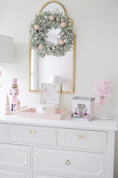 a white dresser with christmas decorations on top