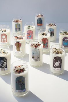 many candles with pictures on them are arranged in the shape of a circle and placed next to each other