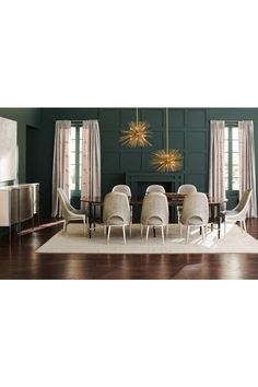 a dining room with green walls and white chairs