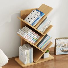 a bookshelf with several books on top of it next to a small desk