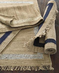 two pieces of woven fabric with fringes on top of each other, one blue and the other beige