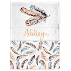 the personalized blanket with feathers on it is shown in orange, blue and white