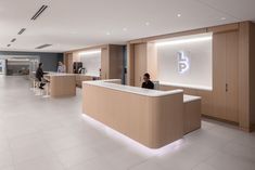 an office with people sitting at desks in front of the counter and on the wall