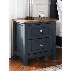 a night stand with two drawers and a clock on top