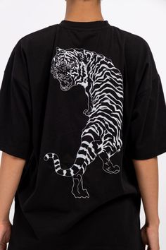 IMperfectionists Classic Tiger design on a 100% cotton textile with the perfect oversize cut. The Tiger and Copenhagen front logo are embroidered to ensure higher quality and durability. The T-shirt size is true to general EU unisex sizes. Material: 100% Deadstock Cotton Color: Black Care instruction - Wash in cold (30°C or below) water - Don't tumbledry - Iron on low heat - Don't wash together with dark or colourful clothes. Longer the use better for our environment, so please apply the followi Black Embroidered T-shirt For Streetwear, Black T-shirt With Embroidered Graphics For Streetwear, Black Embroidered Graphics T-shirt For Streetwear, Oversized Embroidered Tops For Streetwear, Black T-shirt With Embroidered Graphics And Relaxed Fit, Black T-shirt With Embroidered Graphics, Relaxed Fit, Oversized Black T-shirt With Embroidered Graphics, Oversized Black Top With Embroidered Graphics, Oversized Graphic Tee With Embroidered Graphics