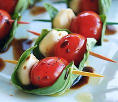 small appetizers with tomatoes and cheese on toothpicks are ready to be eaten