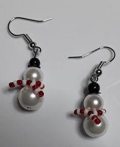 the earrings are decorated with red and white beads