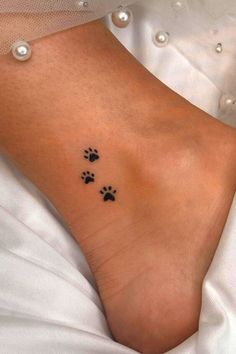 a woman's foot with two paw prints on her left side and the other one is