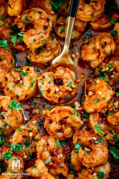 a skillet filled with cooked shrimp and garnished with parsley