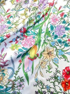 an image of colorful flowers on white fabric