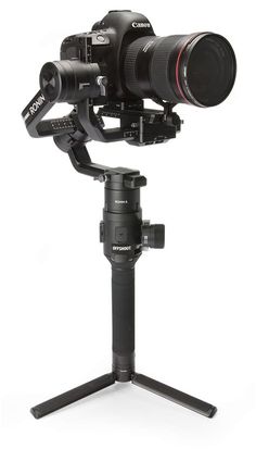 a camera on top of a tripod with a lens attached to the tripod