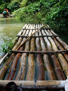 a bamboo raft in the middle of a river