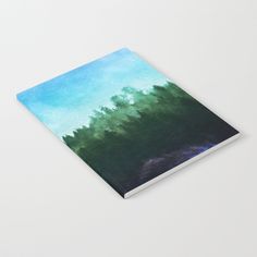 a book with an image of trees on the cover and blue sky in the background