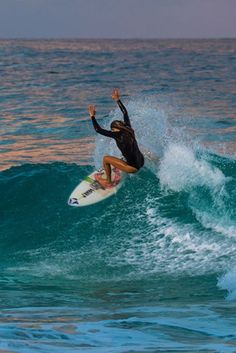 a man riding a wave on top of a surfboard