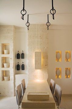 a dining room with white walls and chairs