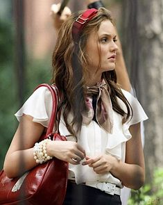 a woman carrying a red purse in her hand