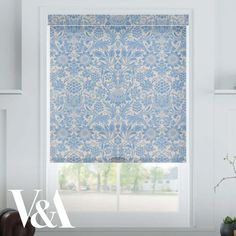 a blue and white roman blind in a living room