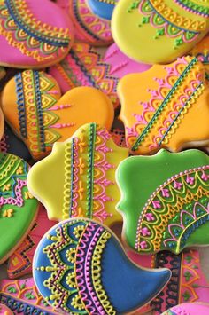 colorful decorated cookies are displayed on a table