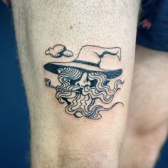 a man's leg with a tattoo on it that has a hat and waves