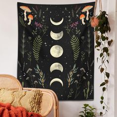 a tapestry hanging on the wall next to a wicker chair and potted plant