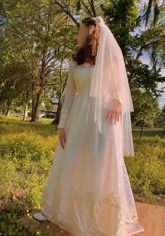 a woman in a white wedding dress and veil