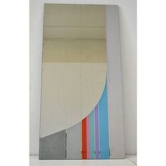 a mirror that is on top of a wall with different colored strips in it and the reflection of an object