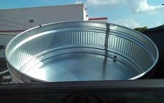 a large metal pan sitting in the back of a truck