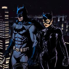 batman and catwoman standing next to each other in front of the city at night