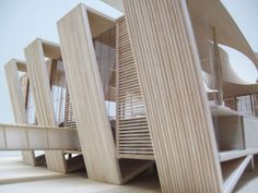 an architectural model of a building made out of wood