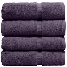 four dark purple towels stacked on top of each other in front of a white background