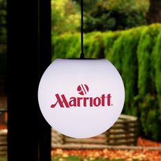 the marriot logo is hanging from a light fixture in front of some trees