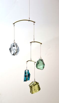 three different colored glass pieces hanging from a wire