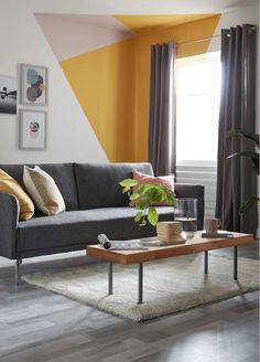 a living room with a couch, coffee table and pictures on the wall