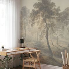 a desk and chair in front of a wall with a painting on the wall behind it