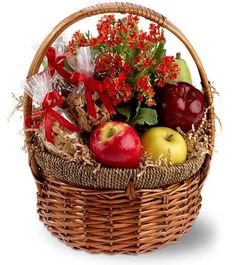 a basket filled with lots of fruit and flowers