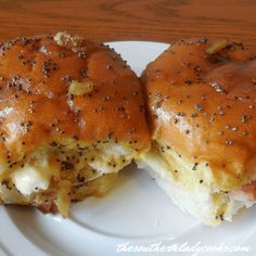 two ham and cheese sliders on a white plate with black pepper sprinkles