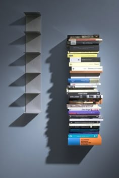 a bookshelf with many books on it next to a wall