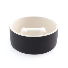 a black and white dog bowl with a bone in it's center on a white background