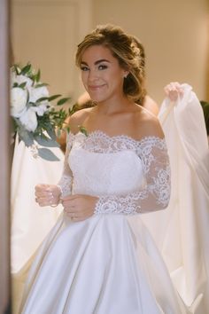 a woman in a white wedding dress is smiling