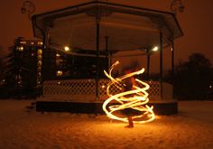 a person standing in the snow with a light painting