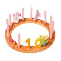 a wooden circle with candles and numbers on it for children to play in the room