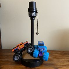 there is a toy truck on top of a sand pit with other toys around it