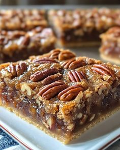 pecan bars are arranged on a white plate