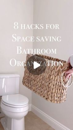 a person holding a basket over a toilet in a bathroom with the words 8 hacks for space saving bathroom organization