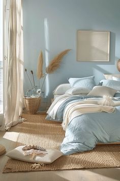 a bedroom with blue walls and white bedding