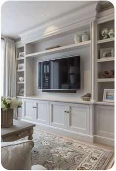 a living room with built in shelves and a flat screen tv