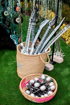 a basket filled with golf balls and tees on top of a grass covered field