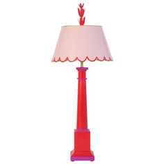 a red table lamp with a pink shade on the base and a white lampshade